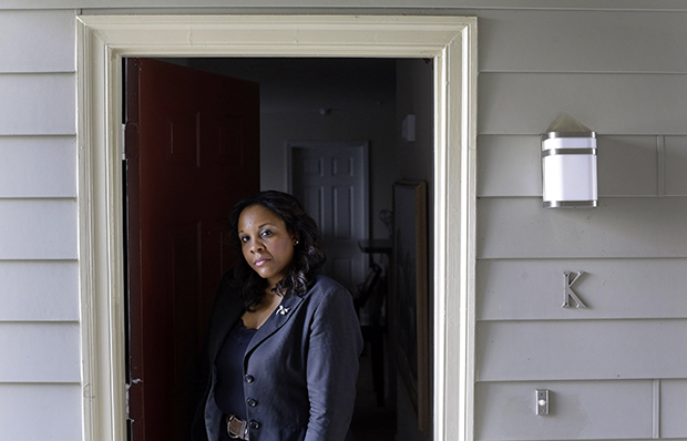 Felicia Evans Long, a program analyst at the National Institutes of Health who is currently furloughed due to the partial federal government shutdown, stands outside her home in Rockville, Maryland, Thursday, October 3, 2013.