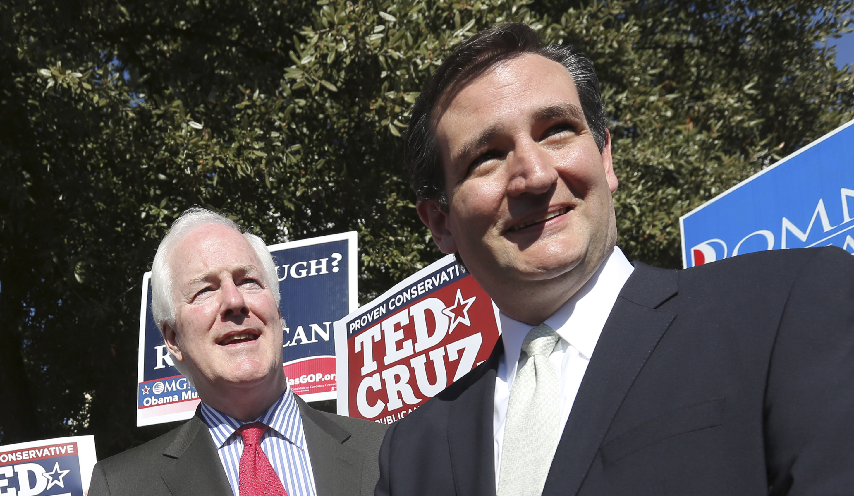Then-Senate candidate Ted Cruz (R-TX), right, and Sen. John Cornyn (R-TX) listen to a question from reporters outside a polling station in Dallas.
