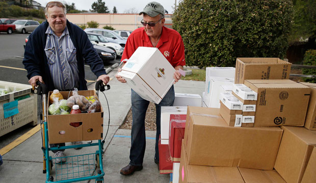 Steve Bosshard hands over a specially prepared box of food to Gordon Hanson at a food bank distribution in Petaluma, California, in January.
