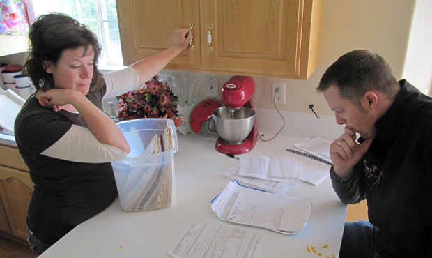 Ben and Amber Sessions look over real-estate documents at their rental home in Rexburg, Idaho, on June 9, 2011.