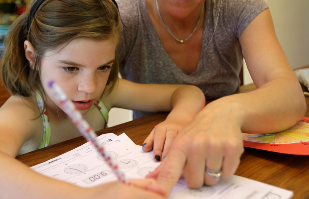 Stacey Jacobson-Francis works on math homework with her 6-year-old daughter at their home in Berkeley, California.