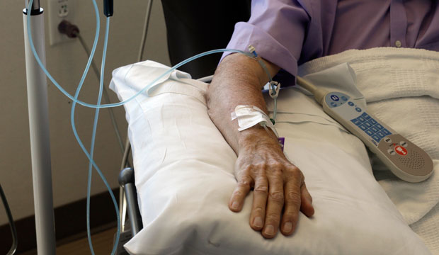 Chemotherapy is administered to a cancer patient.