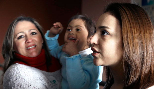 Claudia Ramon and her daughters Isabella and Camila speak outside a town hall forum in Houston. The meeting was held despite an injunction from a federal judge in Texas blocking President Obama’s executive orders on immigration.