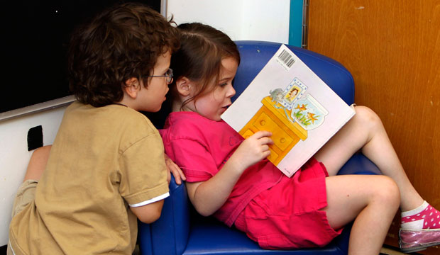 Pre-K students read a book at the Walden Early Childhood Center at Emory University in Atlanta, Georgia.