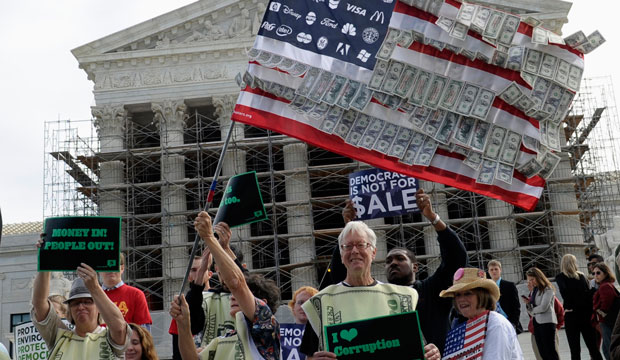 Demonstrators gather outside the Supreme Court in Washington, Tuesday, Oct. 8, 2013, as the court heard arguments on campaign finance.