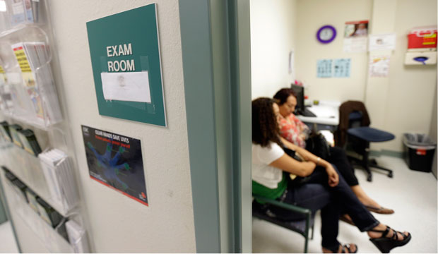 Two women wait in an exam room at Nuestra Clinica Del Valle, in San Juan, Texas, on July 12, 2012.