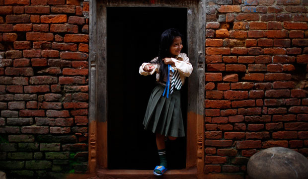 A Nepalese girl gets ready for school.
