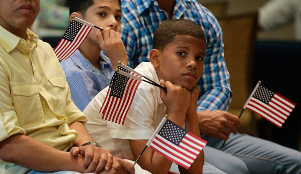 Derek Martinez listens during a citizenship ceremony in New York on May 26, 2015.