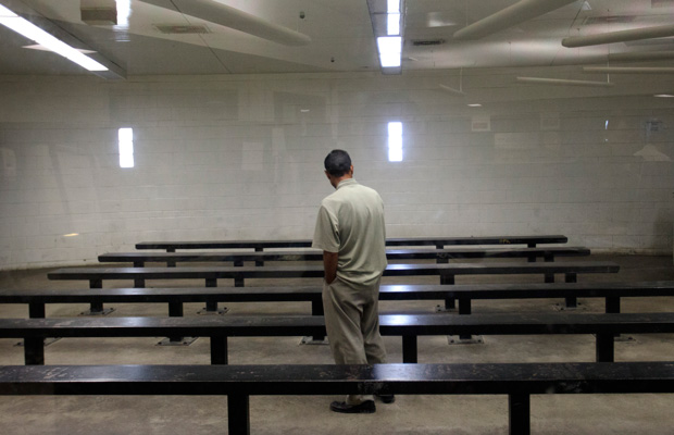 A man waits to be processed at a Border Patrol detention center in Imperial Beach, California, in January 2012.