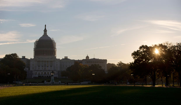 The sun rises behind the U.S. Capitol grounds in Washington, D.C., October 2014.