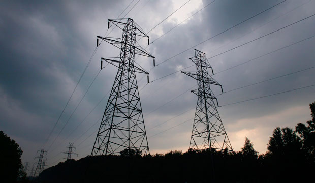 Power transmission lines stand against a sky of gathering storm clouds in Lansing, Michigan, on August 21, 2003.