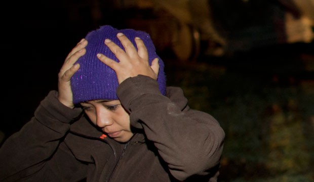 A migrant reacts after being taken into custody