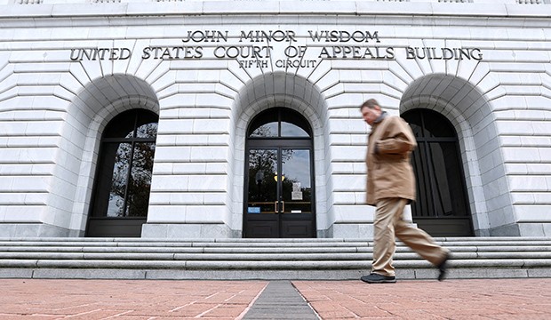 A man walks in front of the U.S. Court of Appeals for the 5th Circuit.