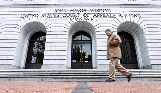 A man walks in front of the U.S. Court of Appeals for the 5th Circuit, January 7, 2015.