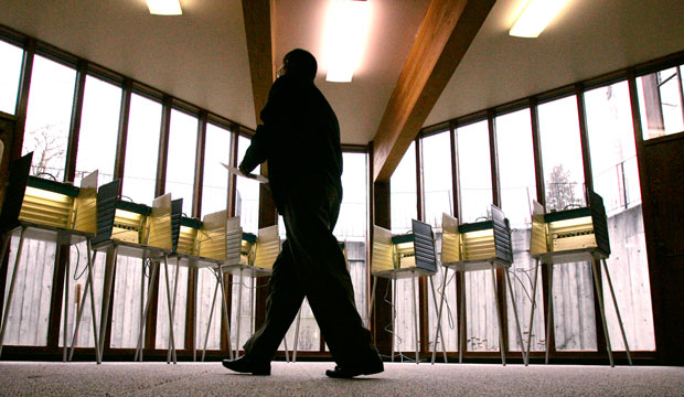 A voter walks toward an empty bank of voting stations at a polling place in Seattle on the day of Washington state's 2008 presidential primary.